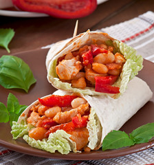 Burrito with chicken, beans, tomatoes and sweet peppers