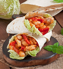 Burrito with chicken, beans, tomatoes and sweet peppers