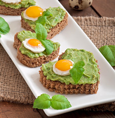 Sandwich with avocado paste and egg in the shape of heart