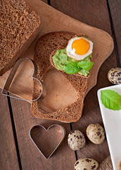 Sandwich with avocado paste and egg in the shape of heart