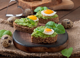Sandwich with avocado paste and egg in the shape of heart