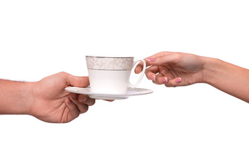 Hand giving cup and saucer