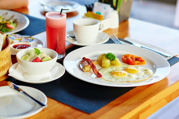 Fried eggs, fruit salad and fresh juice