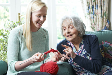 Grandmother Showing Granddaughter How To Knit