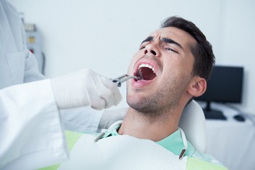 Close up of man having his teeth examined