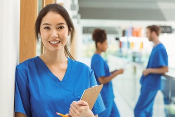 Medical student smiling at camera in hallway