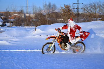 Santa Claus riding on a bike MX through deep snow © VVKSAM