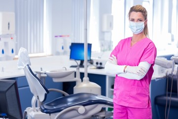 Fototapeta premium Dentist in surgical mask standing with arms crossed