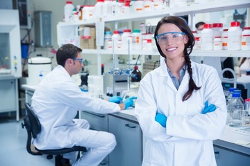 Portrait of a smiling chemist with arms crossed