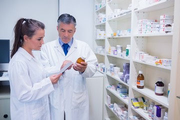 Pharmacist and trainee talking together about medication
