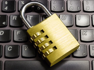 Locked combination padlock on keyboard symbolizing data security