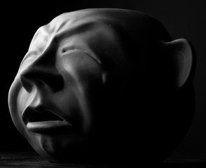 Portrait of sculpture, expression of sorrow, monochrome