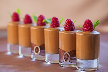 Group of glasses with chocolate mousse.
