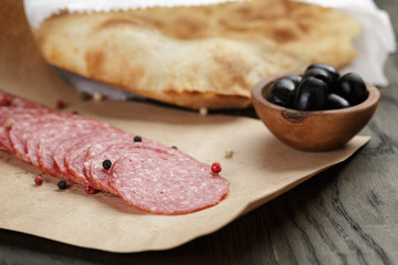dried salami sausage on paper ready for sandwich