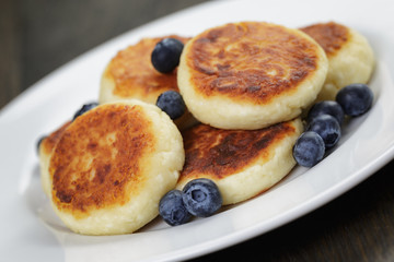 homemade curd fritters on plate with berries