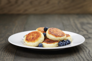 homemade curd fritters on plate with berries