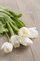 white tulips on rustic wood background