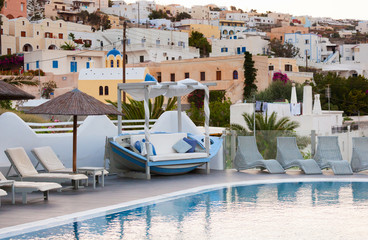 View of Fira town from a resort with swimming pool.