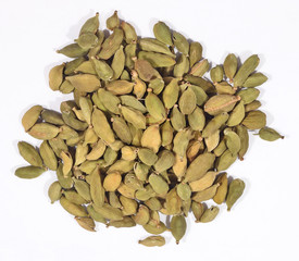 Heap of cardamom seeds on a white