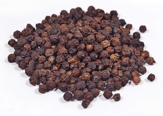 Heap of black pepper on a white