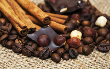 Coffee beans with cinnamon sticks and chocolate
