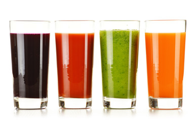 Glasses with fresh vegetable juices isolated on white