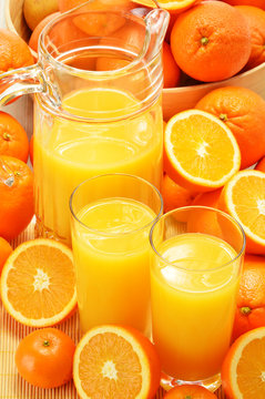 Composition with glasses of orange juice and fruits