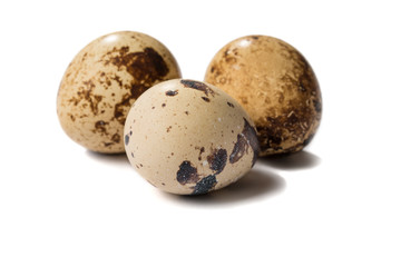 Three quail eggs isolated on white