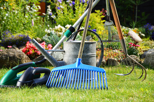 Watering can and tools in the garden