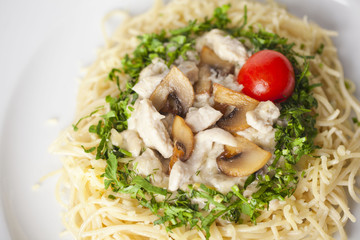 pasta with mushrooms and cherry tomatoes, lined by a circle of