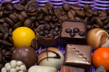 chocolate pralines and coffee beans in lavender basket