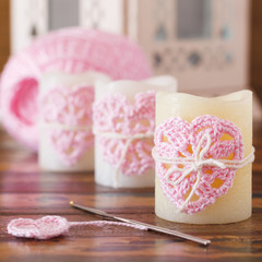 Handmade crochet pink heart on candle for Saint Valentine's day