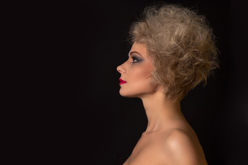 Portrait of girl in profile with lush hair and evening make-up