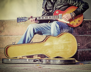 guitar player with open guitar case in vintage tone