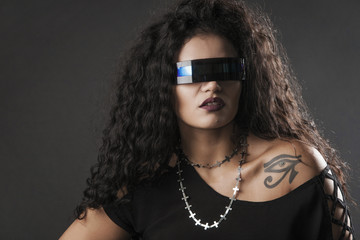 Beautiful rocker girl wearing futuristic sunglasses