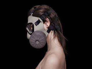 Beautiful girl wearing gas mask profile