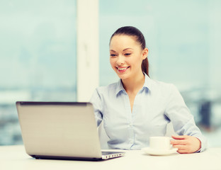 smiling businesswoman or student with laptop