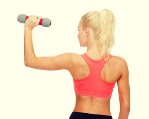young sporty woman with light dumbbell