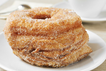 coffee and croissant-doughnut pastries sprinkled with sugar
