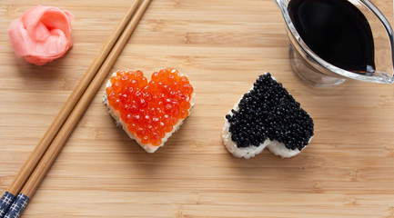 Two heart shaped sushi with salmon roe and beluga caviar