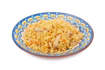 Pilaf dish, bulgur wheat with meat on ceramic plate isolated on
