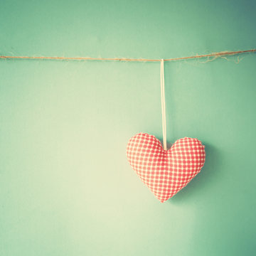 Vintage stuffed cotton heart hanging on a line