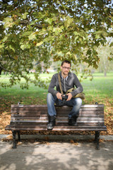 Fototapeta premium Man With Glasses and Camera Autumn Park