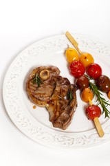 Lamb Chops with cherry tomato. Selective focus.