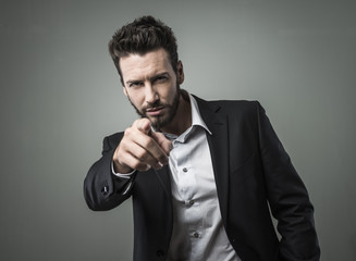 Confident businessman pointing