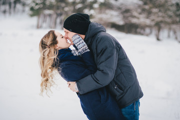 Young couple walking in a winter countryside