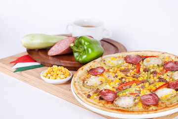 Italian pizza with squash, zucchini, corn, peppers, sausage,