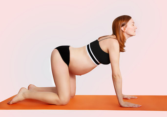 Pregnant woman doing yoga and relaxing