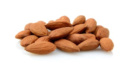 Group of brown almonds isolated on white