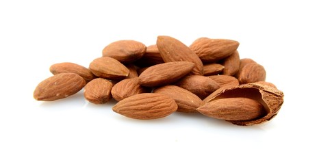 Group of brown almonds isolated on white